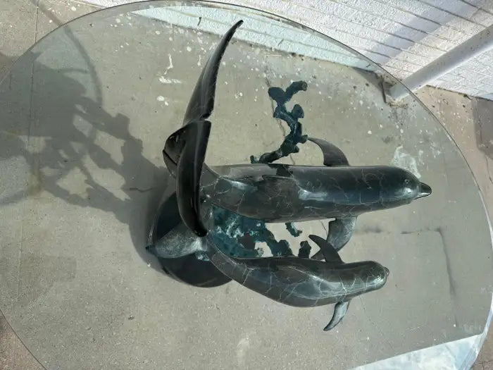 Collectible bronze dolphin table with sculptural base