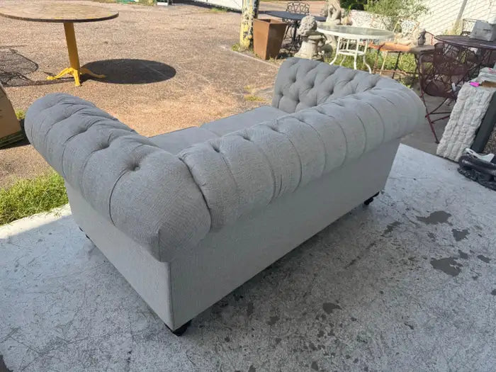Traditional Chesterfield loveseat with deep button tufting