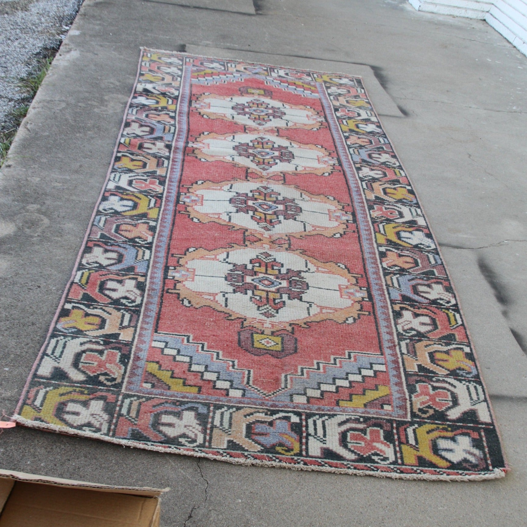 Traditional pink carpet runner with ornate border design