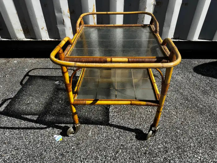 Tiki style rolling bar cart with clear glass tiers
