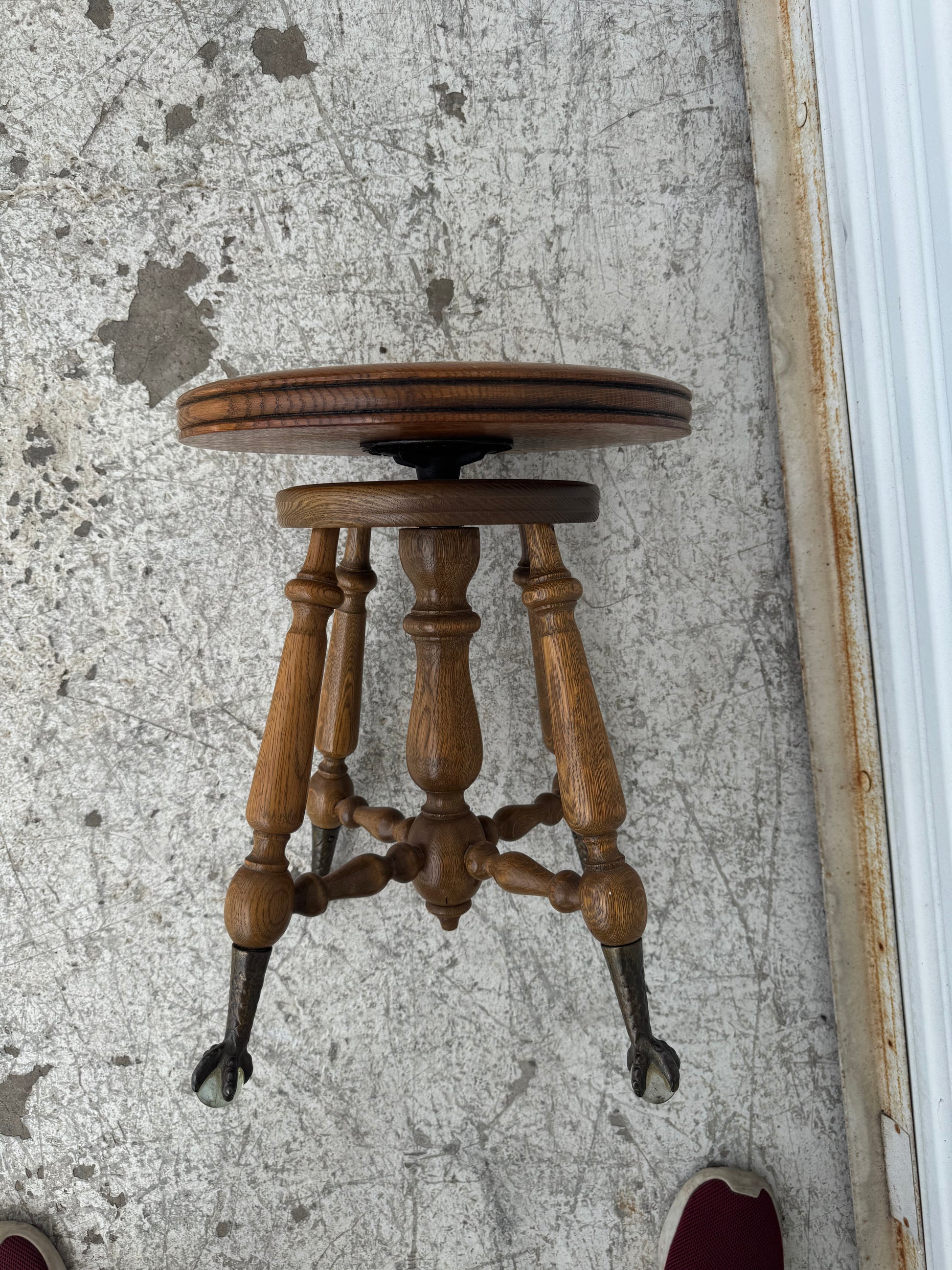 Vintage claw and ball piano stool with original adjustable swivel mechanism visible