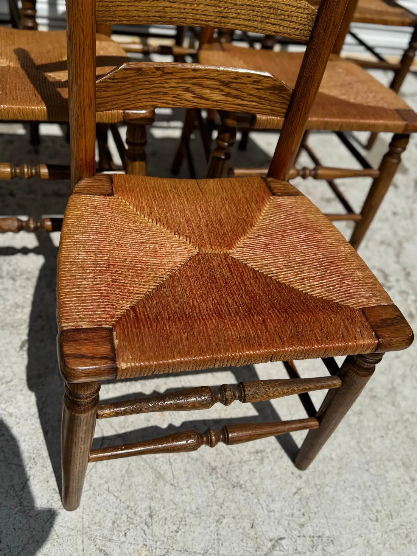 Set of six oak ladderback chairs with woven rush seats