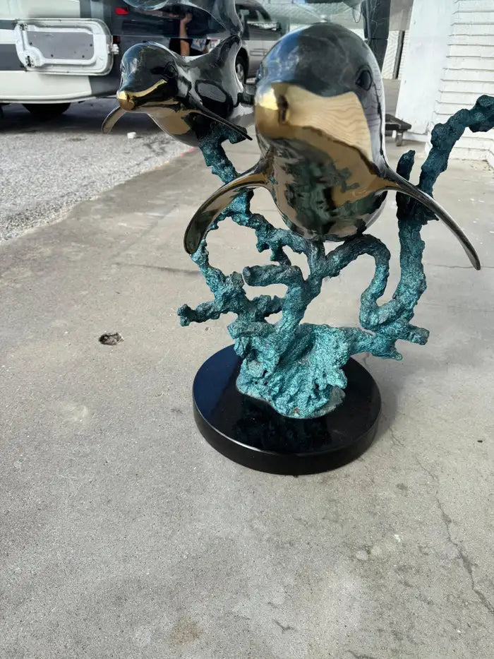Bronze dolphin table showcasing dynamic movement