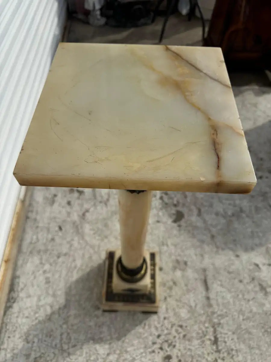 elegant stone display column with bronze and enamel accents