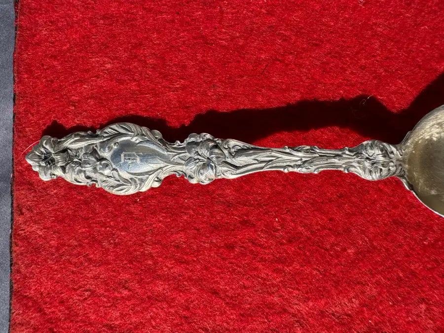 vintage silver spoon with etched decorative pattern