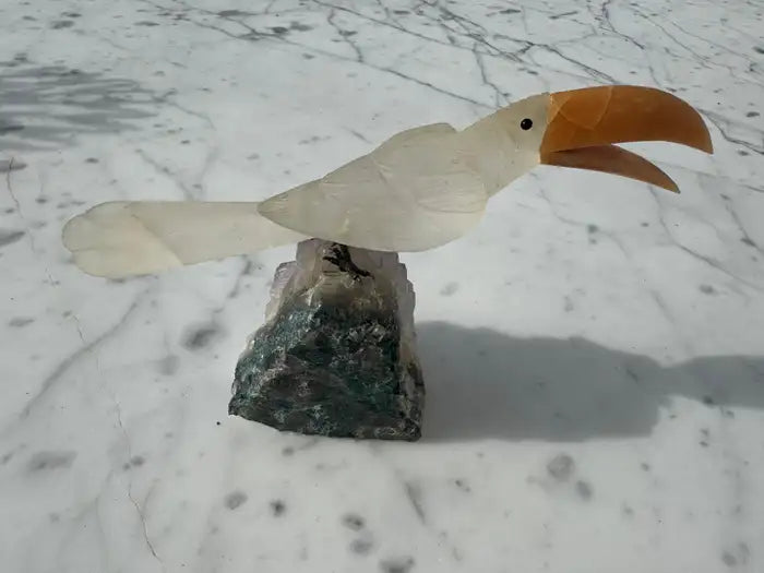 Amethyst geode with quartz toucan figurine