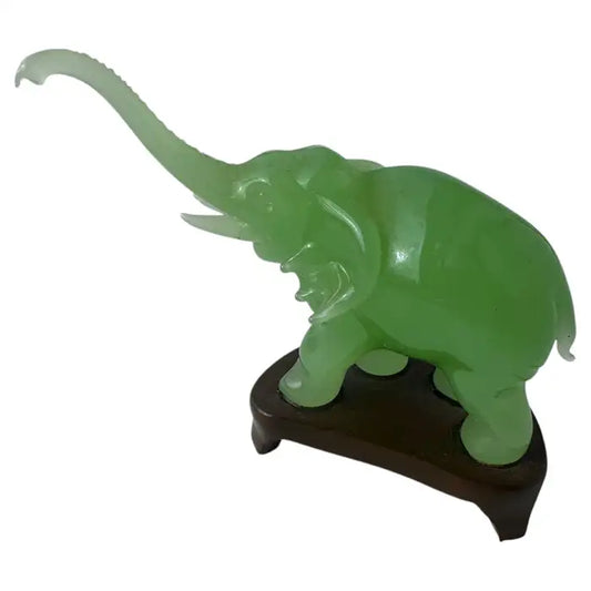 Vintage green jade elephant figurine on wooden stand