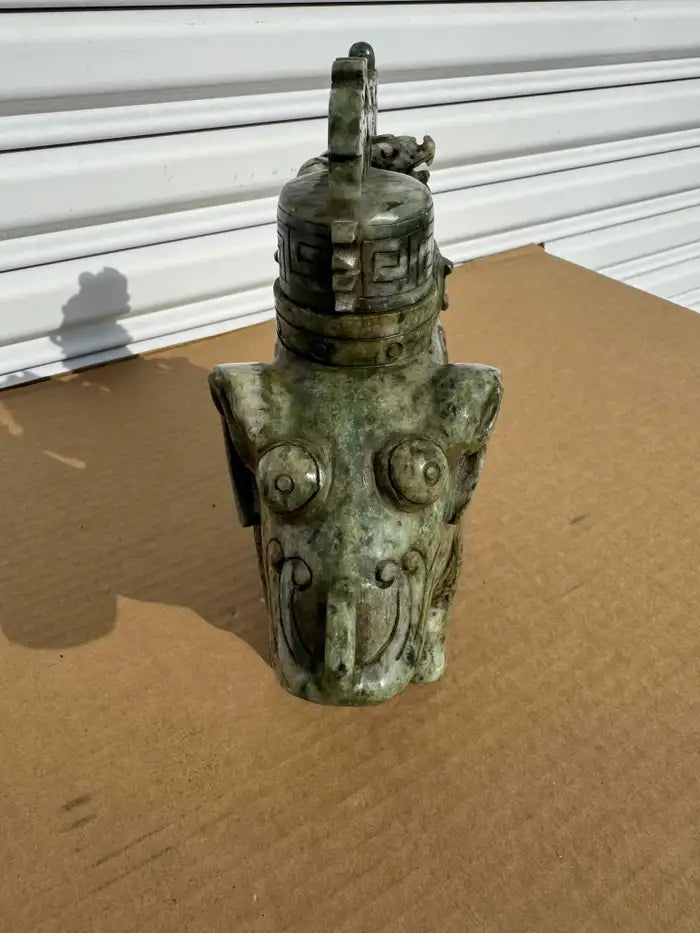 Jade ram sculpture featuring natural stone veining