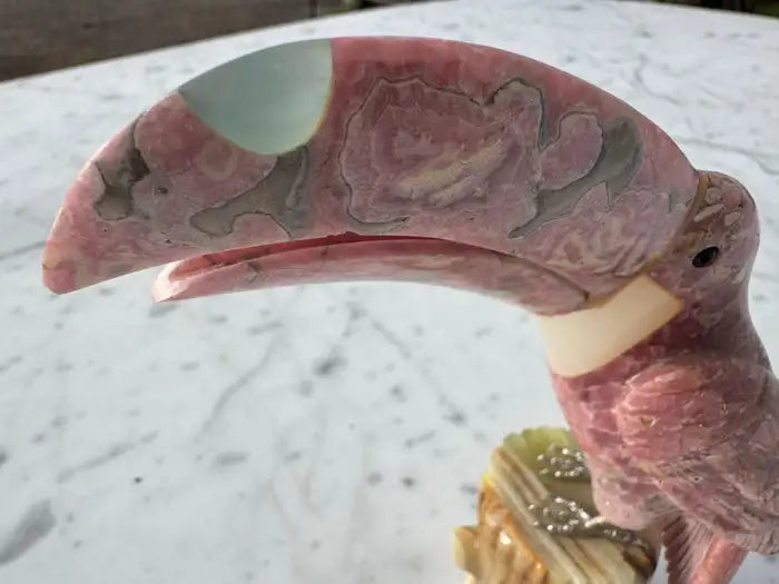 Decorative quartz parrot on polished onyx stump