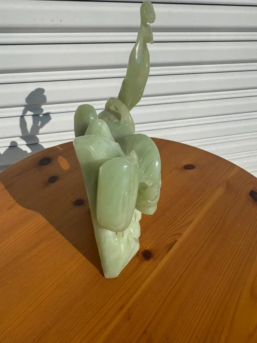 Green jade cow figurine with nursing calf detail