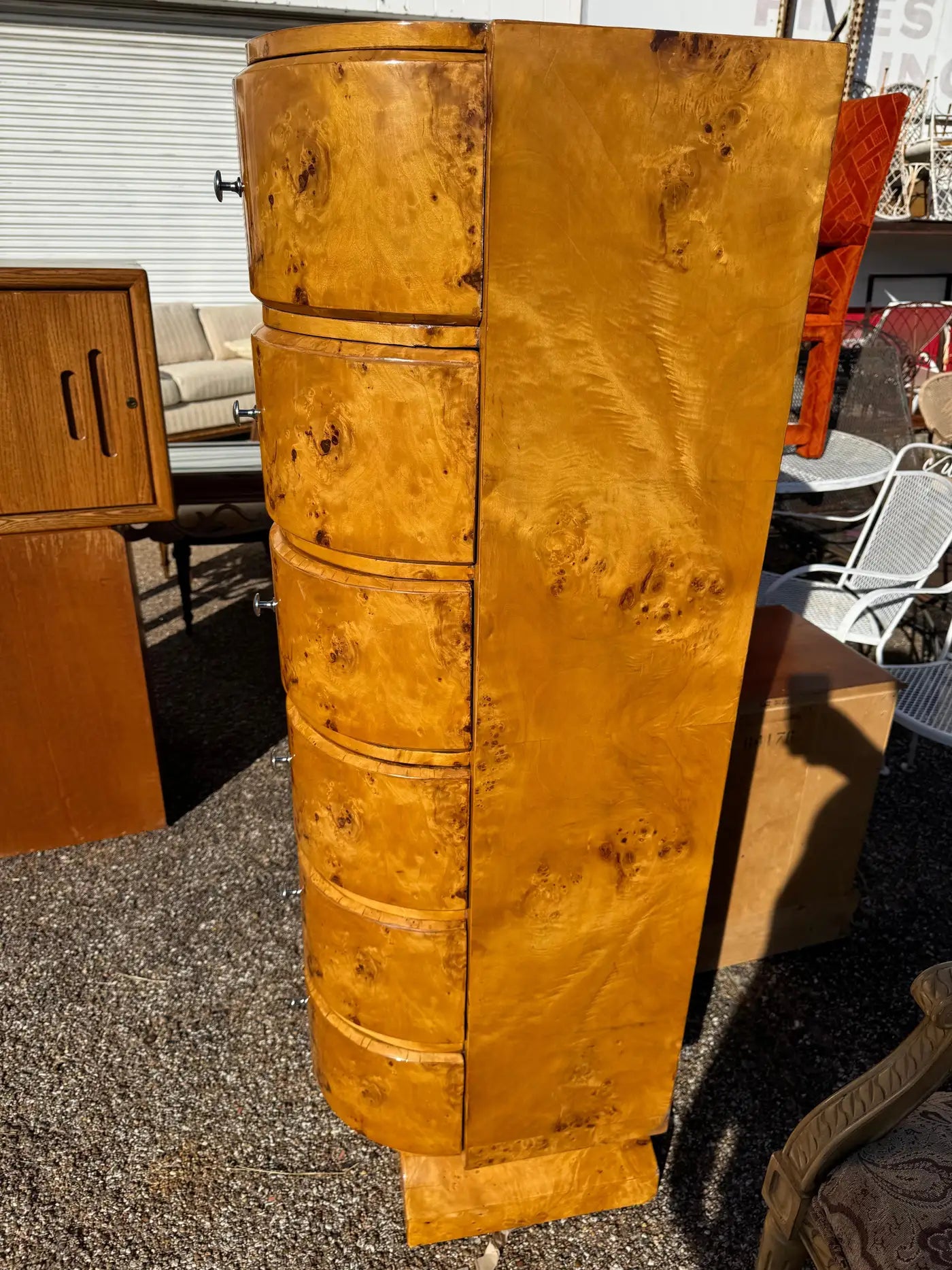Narrow burl wood storage tower with sculpted base and rounded drawer fronts
