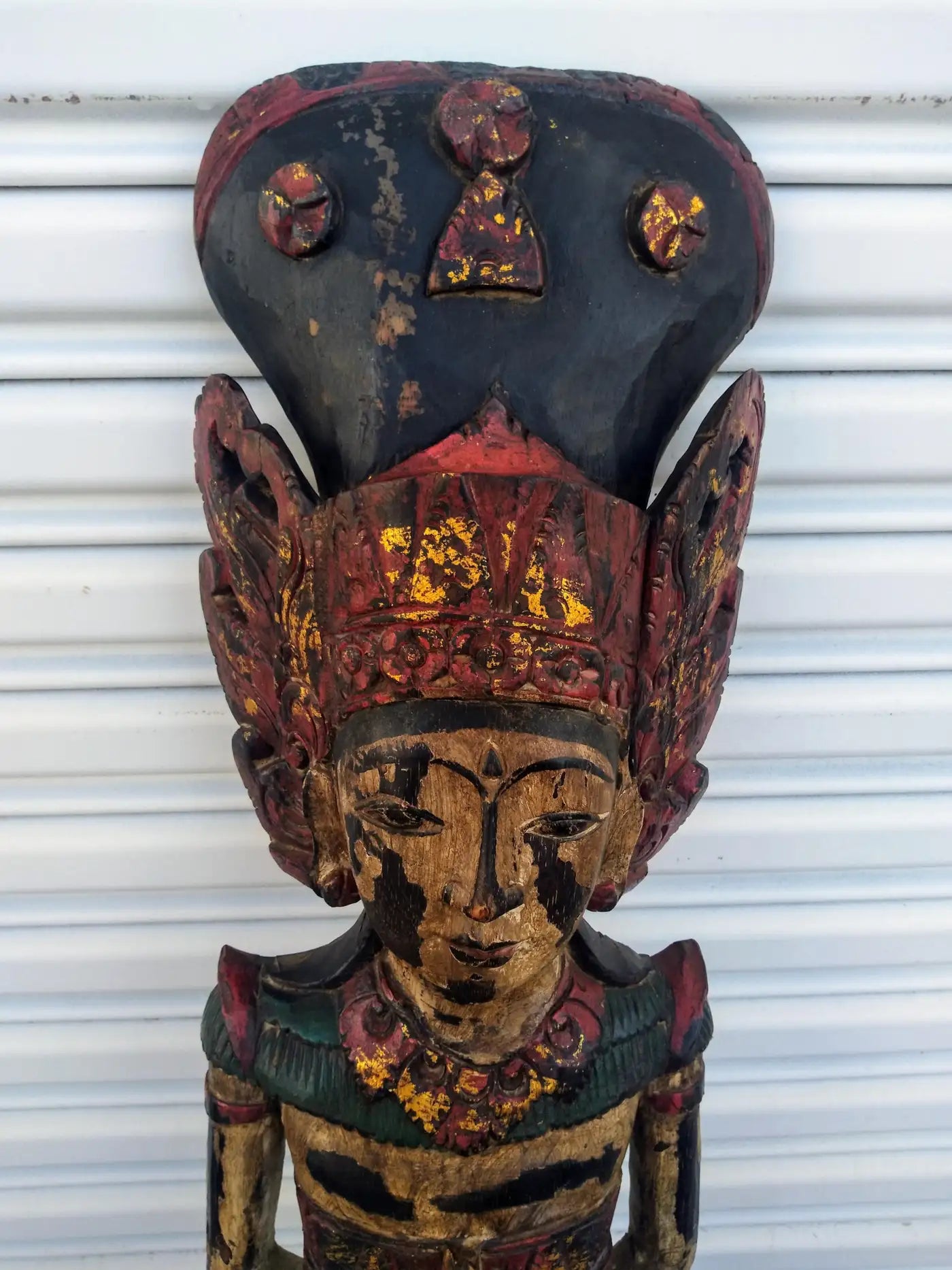 Hand-carved wood statue of Buddhist figure