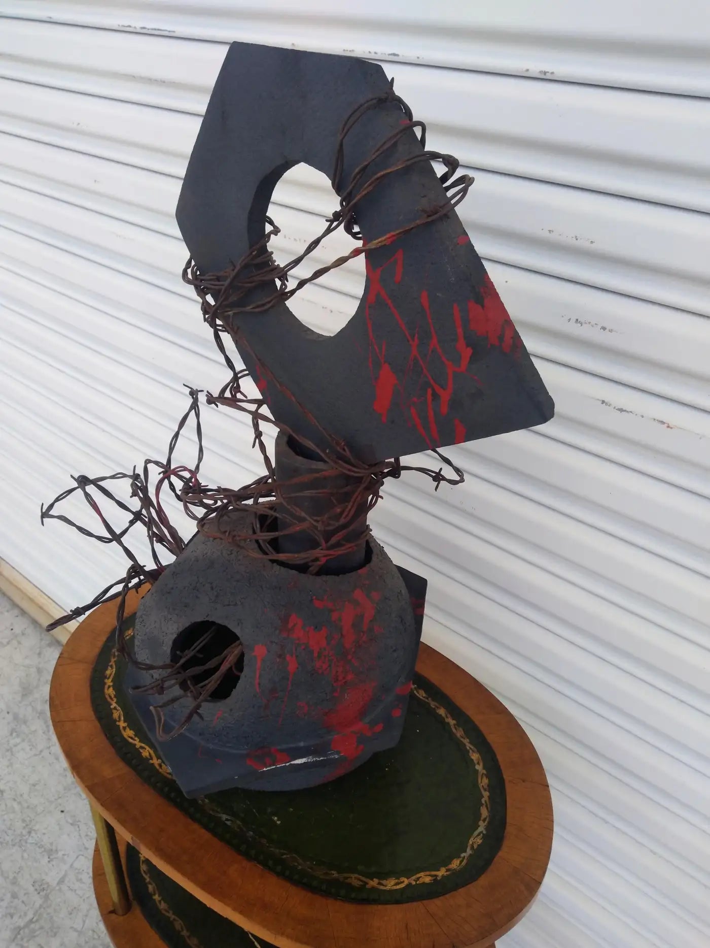 Abstract Raku sculpture wrapped in barbed wire