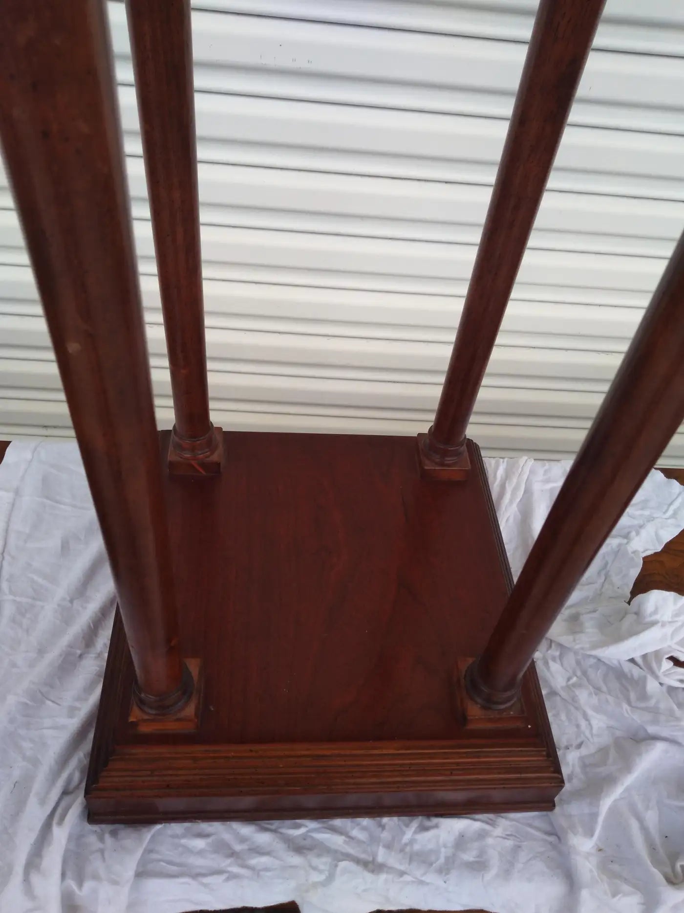 Close-up of mahogany square pedestal with classic details