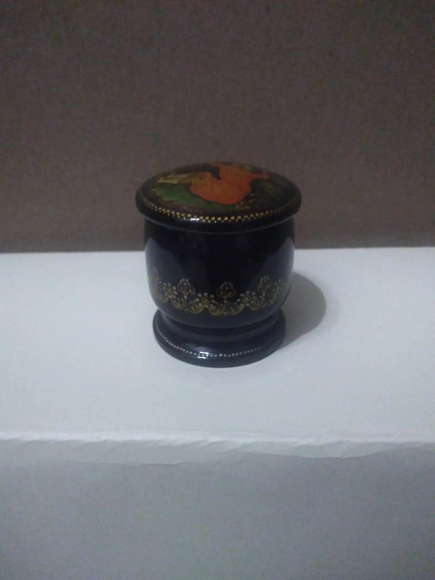 Close-up of hand-painted Russian lacquer box with pin