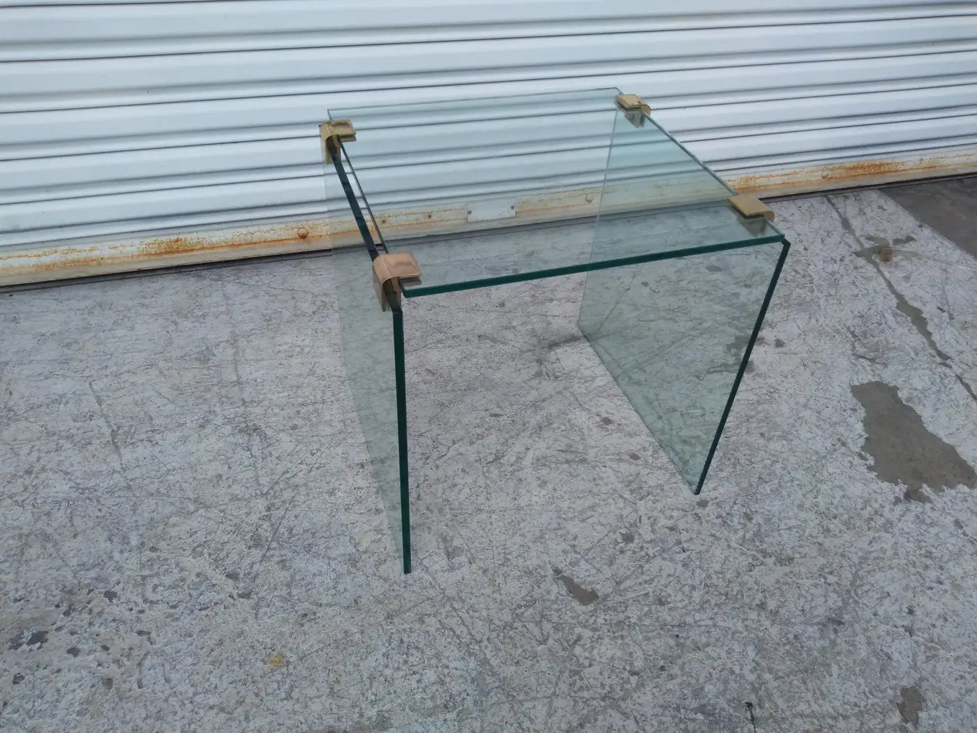 Glass coffee table with brass accents in Pace style