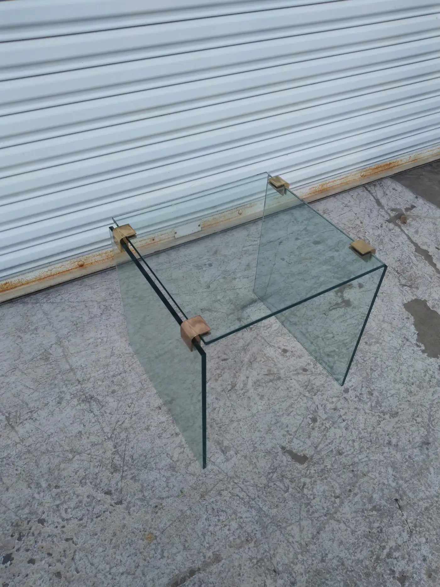 Stylish glass table with brass accents in Pace style