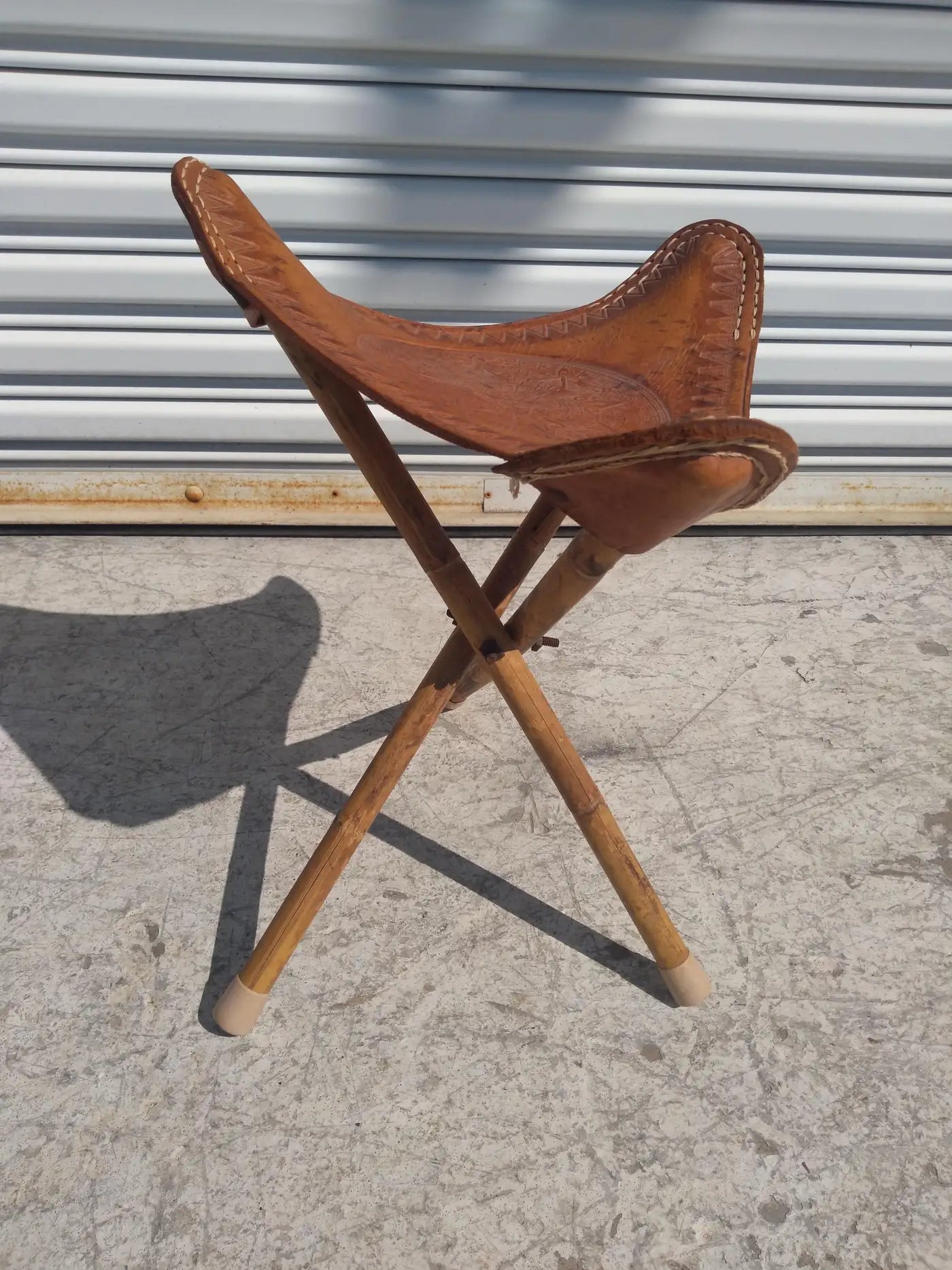 Vintage tripod stool for rustic decor