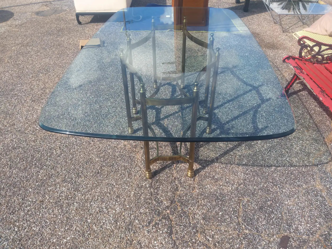 Glass top dining table with neoclassical brass base