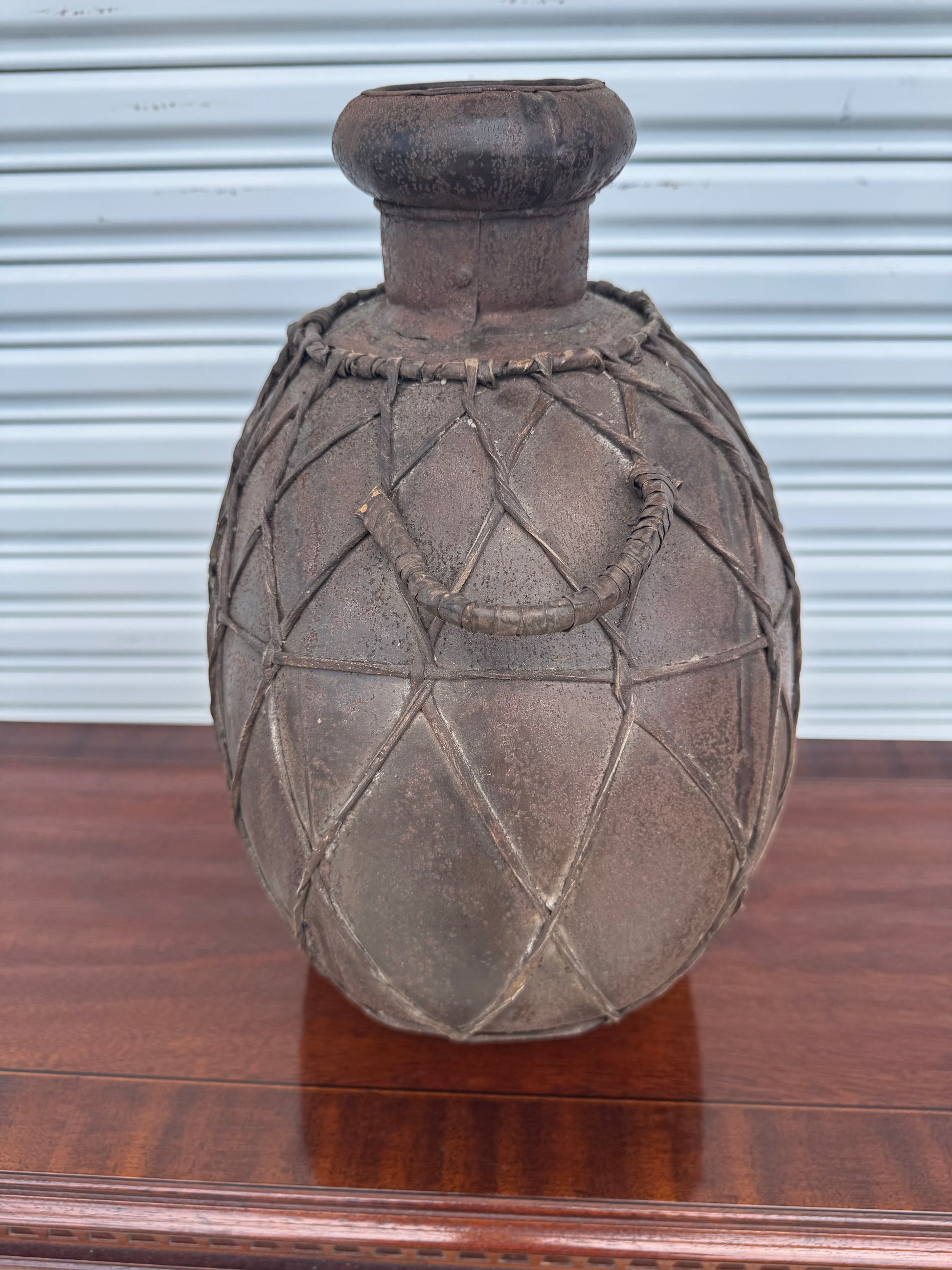 Top angle of a brown artisan jug, showing detailed craftsmanship and handmade design