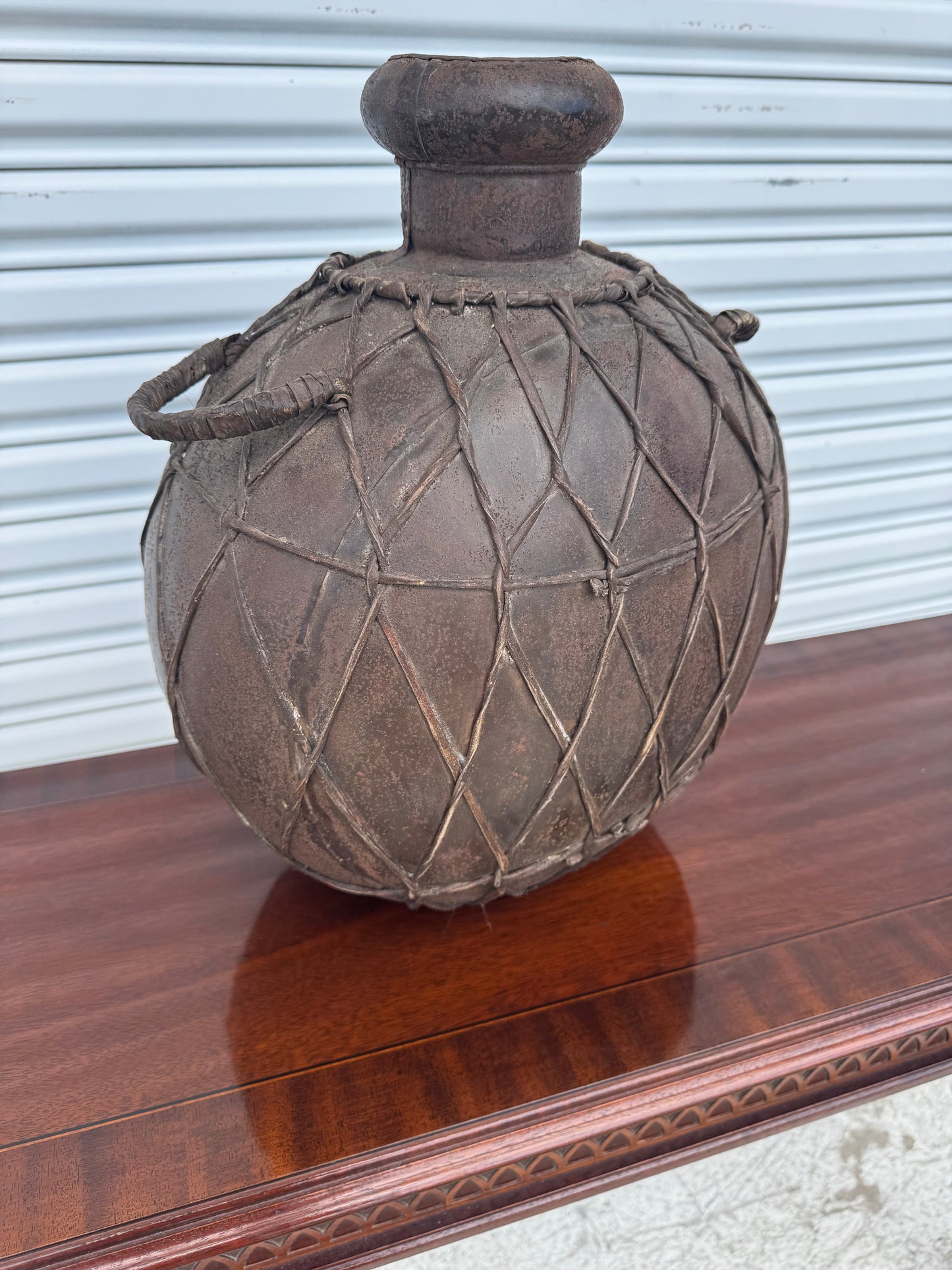Old-world pottery jug centerpiece with earthy tones and sturdy rope handles