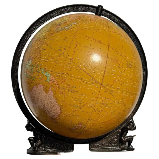 illuminated world globe with wooden stand and vintage map