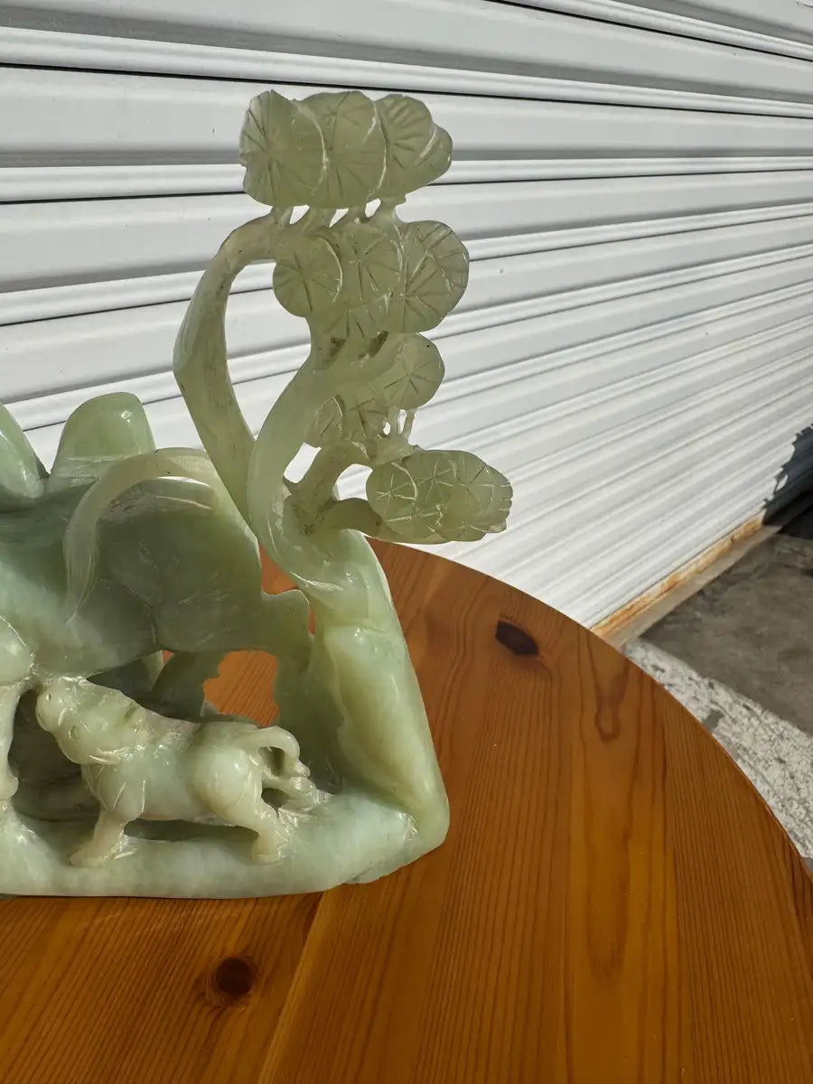 Asian style jade carving cow with calf feeding