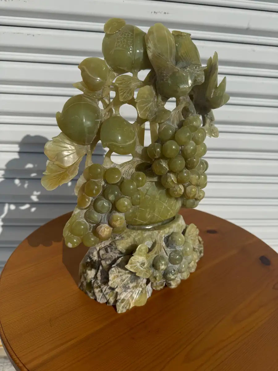 Decorative jade carving with grapes and birds centerpiece