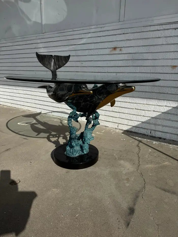 Bronze dolphin sculpture table with natural marble surface