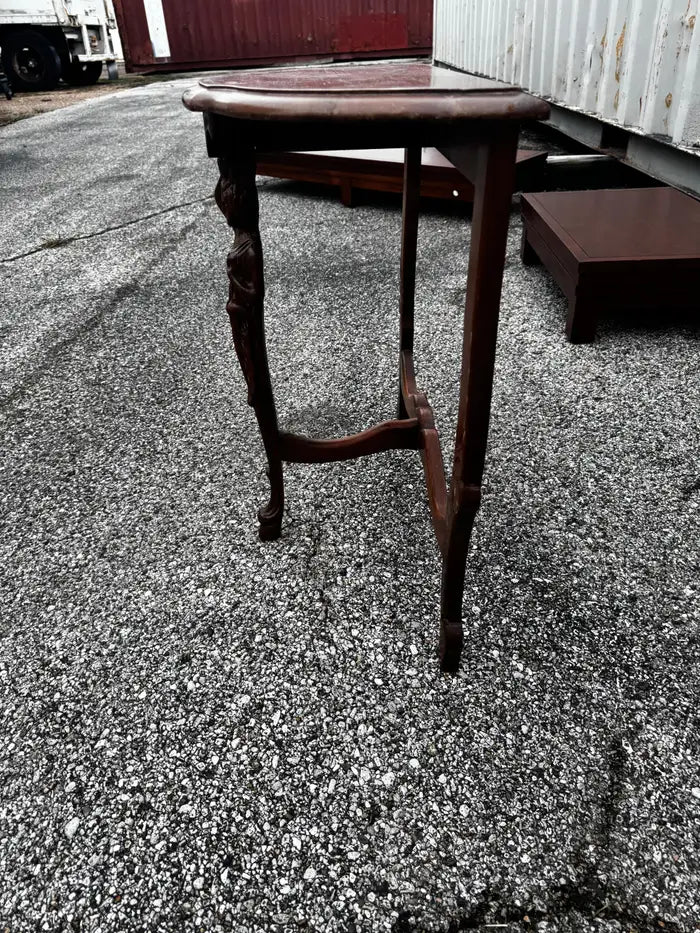 Antique demilune table photographed on marble backdrop
