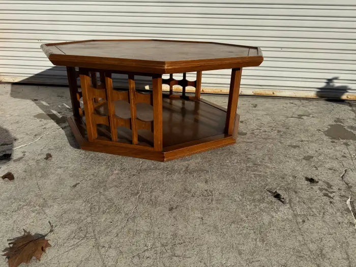 Mid century modern coffee table featuring octagonal walnut design