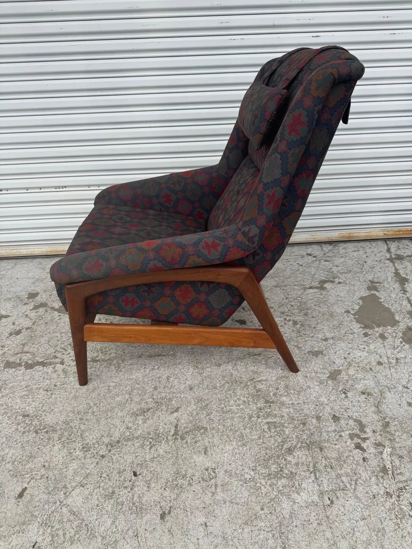 Detail of teak wood frame and sculpted arms on Folke Ohlsson DUX recliner for mid century furniture collection.