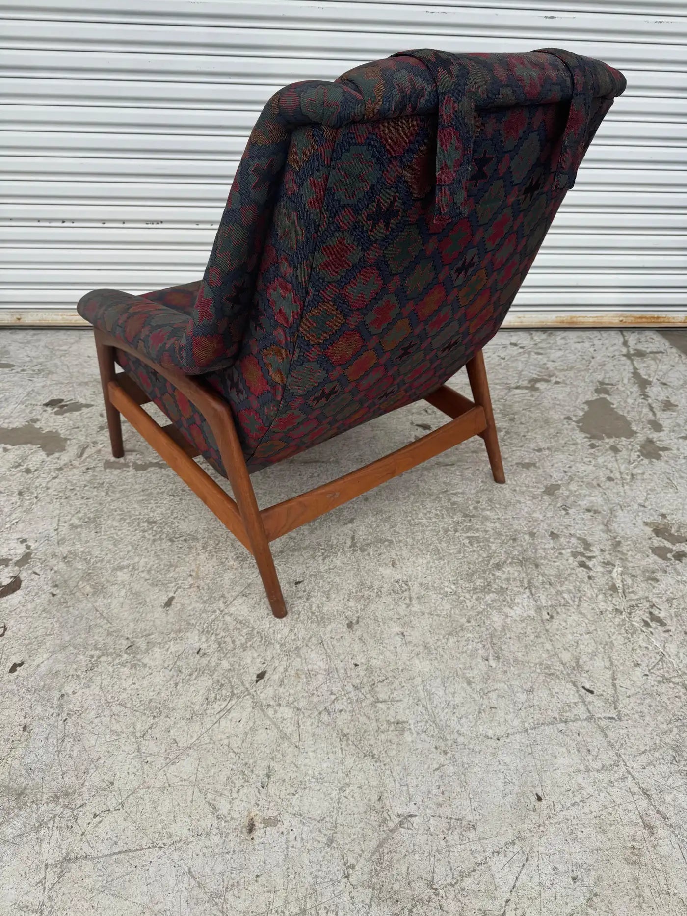 Swedish modern teak armchair with patterned cushions styled as a comfortable accent chair for home décor USA.