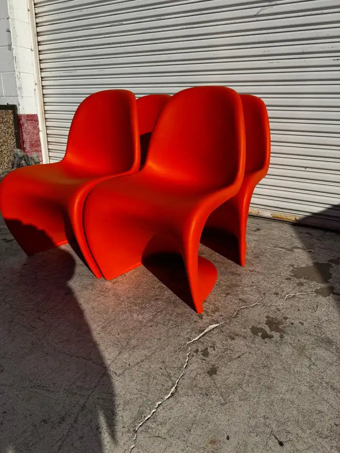 Modern sculptural dining chairs on marble floor