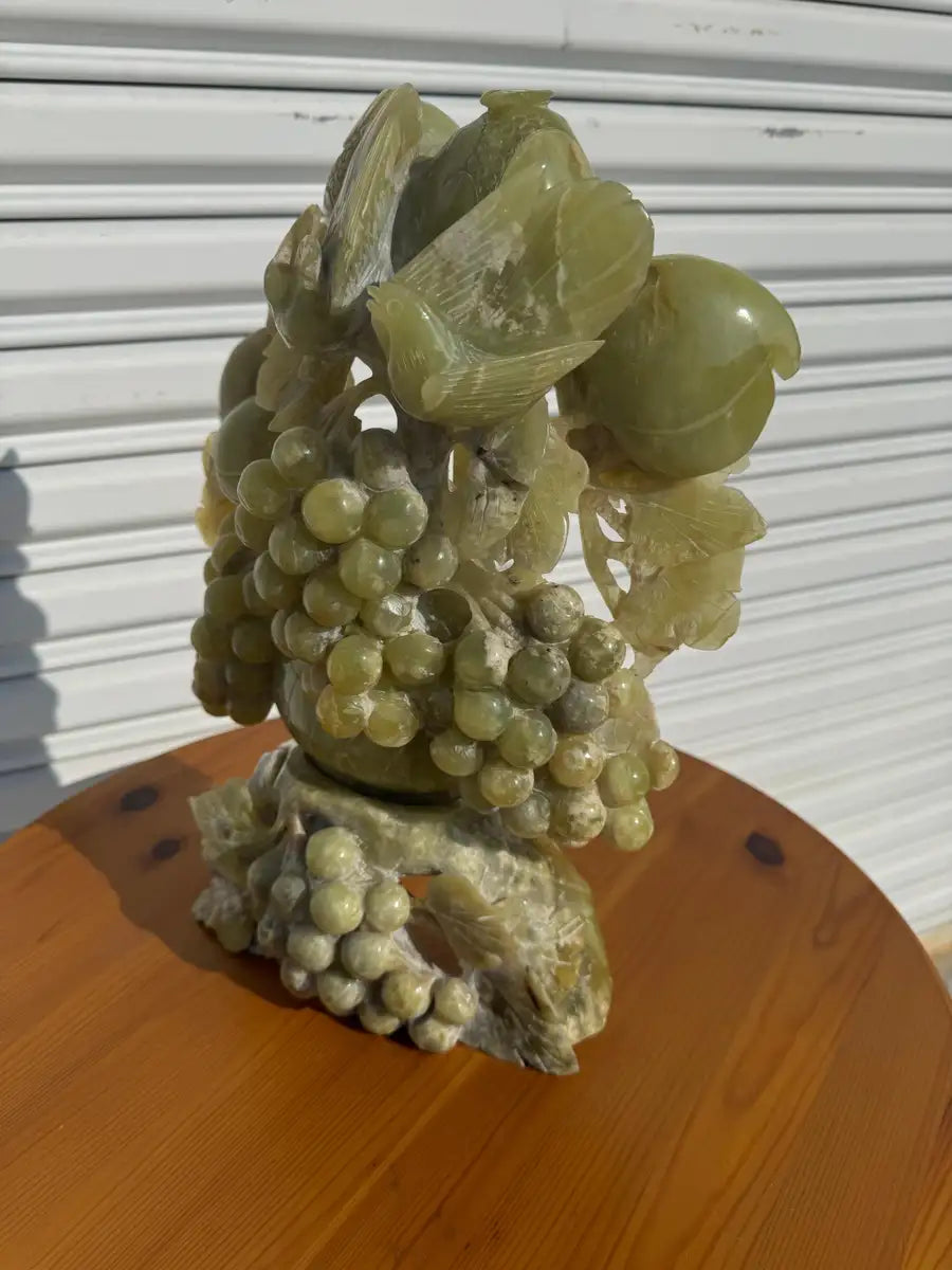 Solid jade figurine with grapevine and bird accents