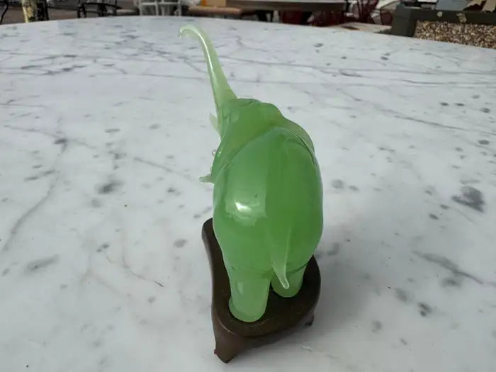 Natural jade elephant statue with carved wood base