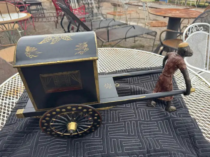 Ornamental monkey sculpture with wheeled metal carriage