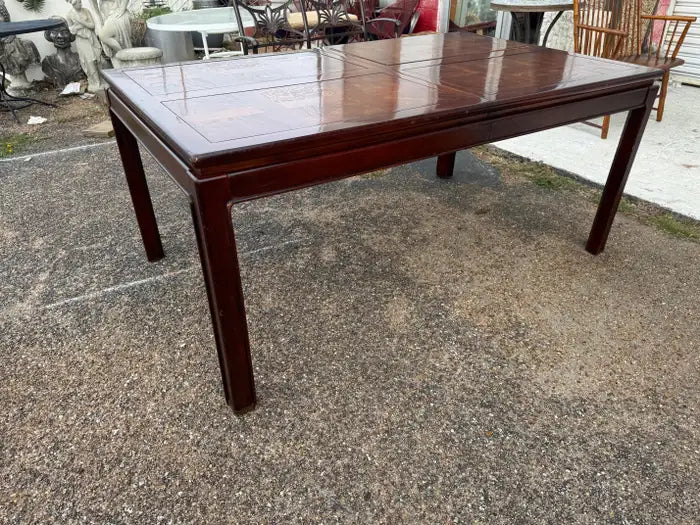 Burl veneer dining table on marble floor