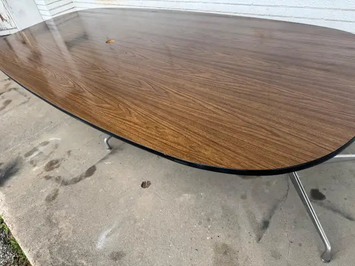 Large walnut oval meeting table for professional workspace