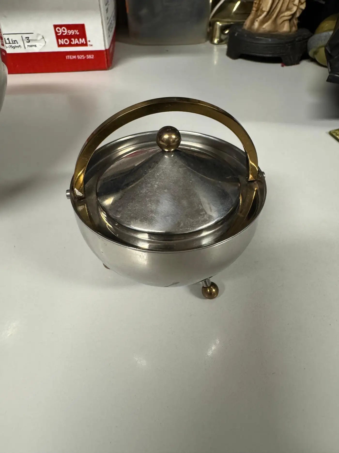 Collectible Bodum stainless steel ball tea set styled for contemporary dining table décor in silver and brass tones