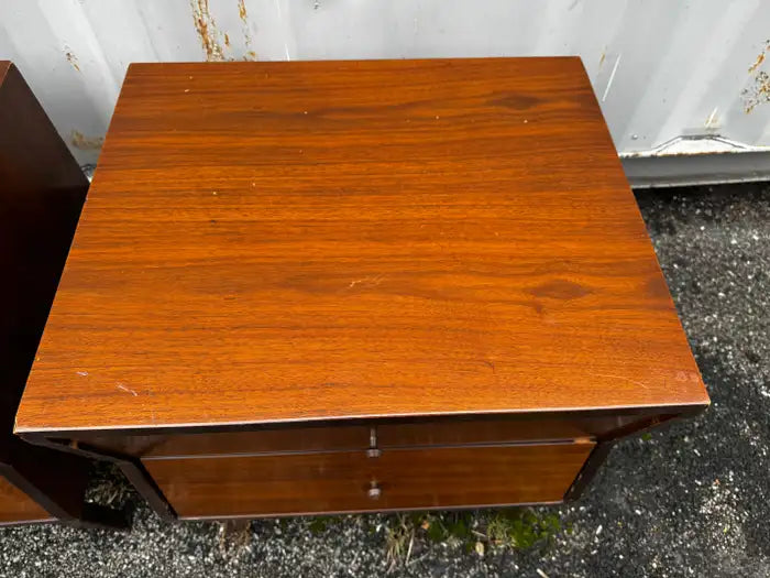 Sculpted walnut bedside tables with rich wood grain