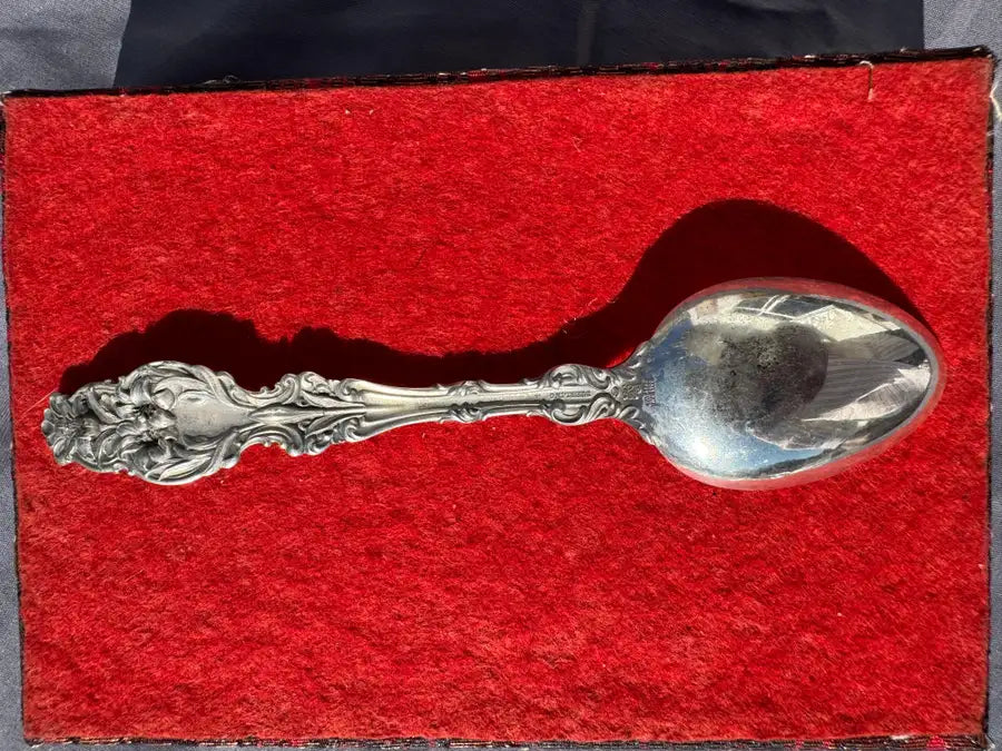 antique spoon with detailed engraving and polished finish