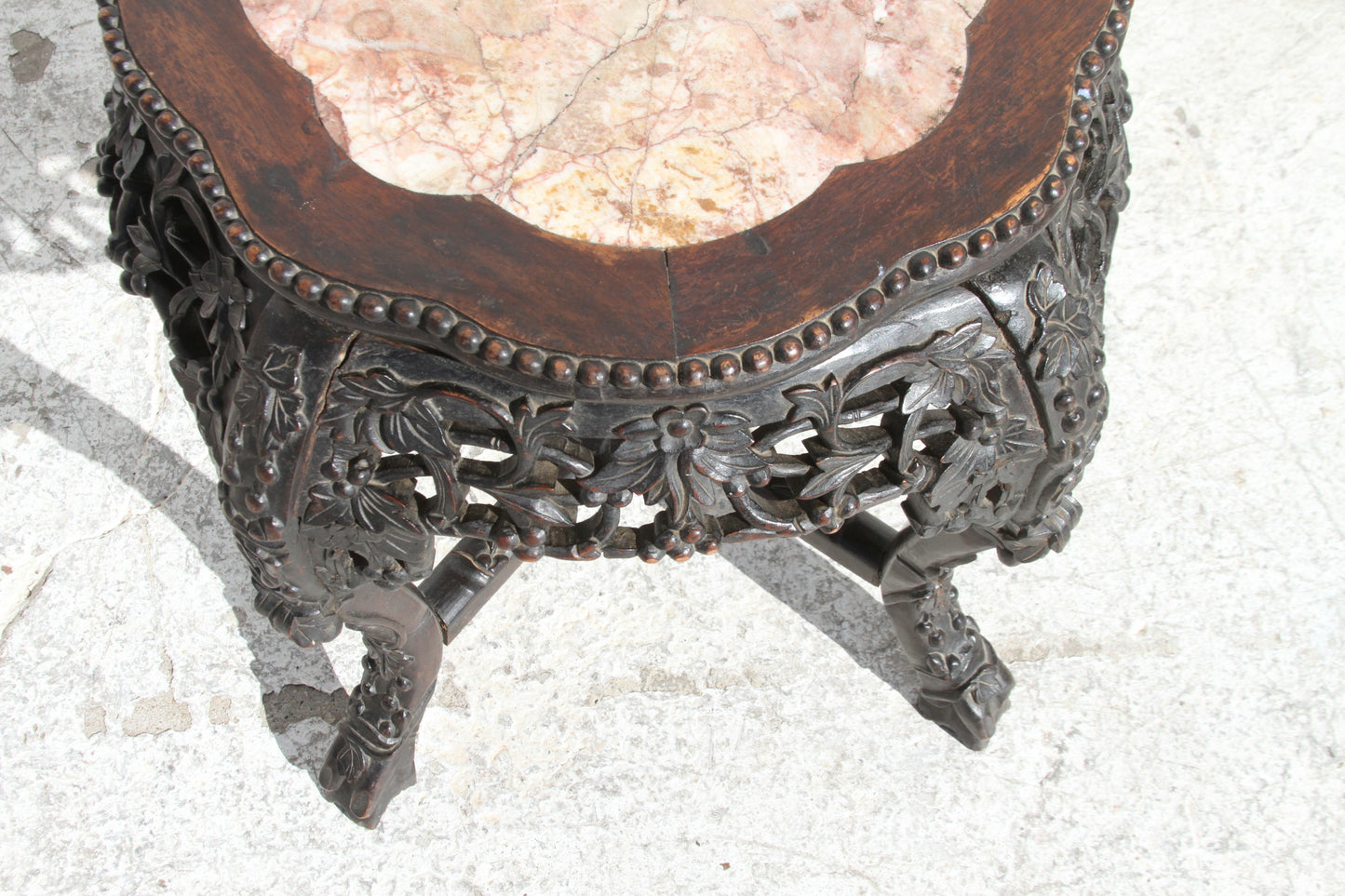 Chinese hardwood pot stand. The marble inset top adds a touch of refinement to this masterpiece.