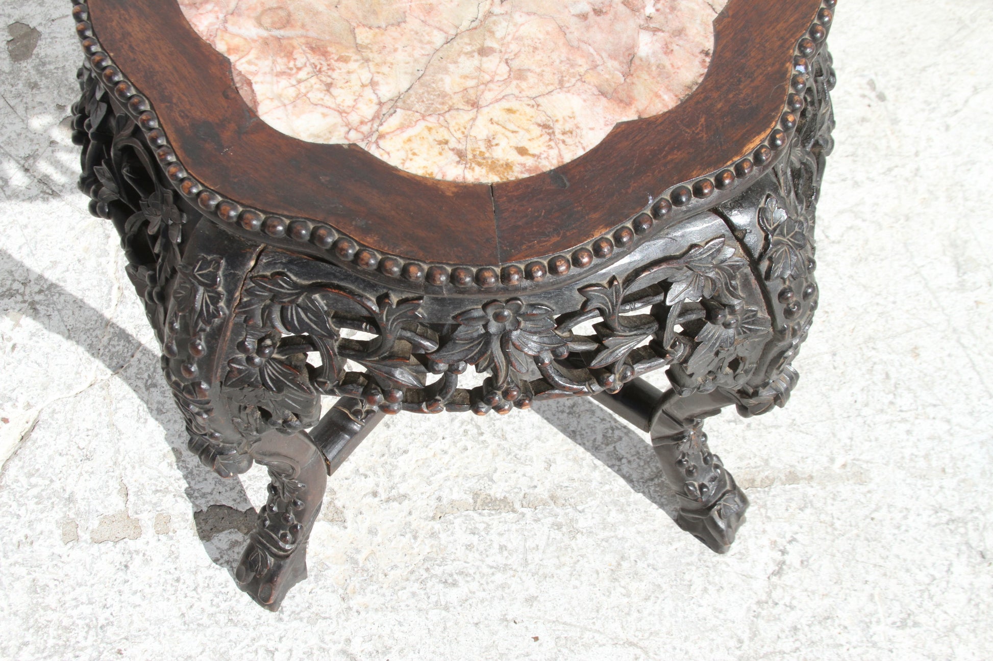 Chinese hardwood pot stand. The marble inset top adds a touch of refinement to this masterpiece.