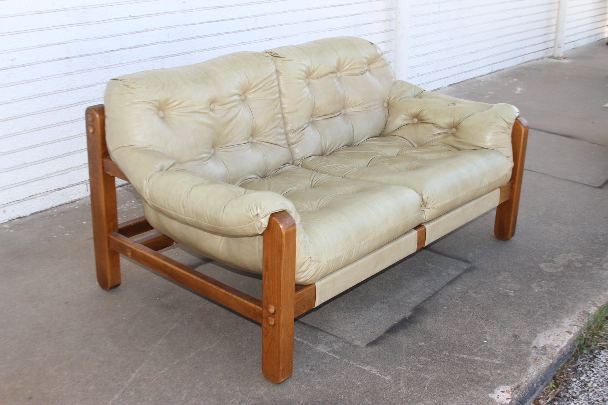 Elevate your living space with the iconic lines and luxurious craftsmanship of this Mid Century teak loveseat. A true investment piece, this love seat sofa is a must-have for any Mid-Century enthusiast.