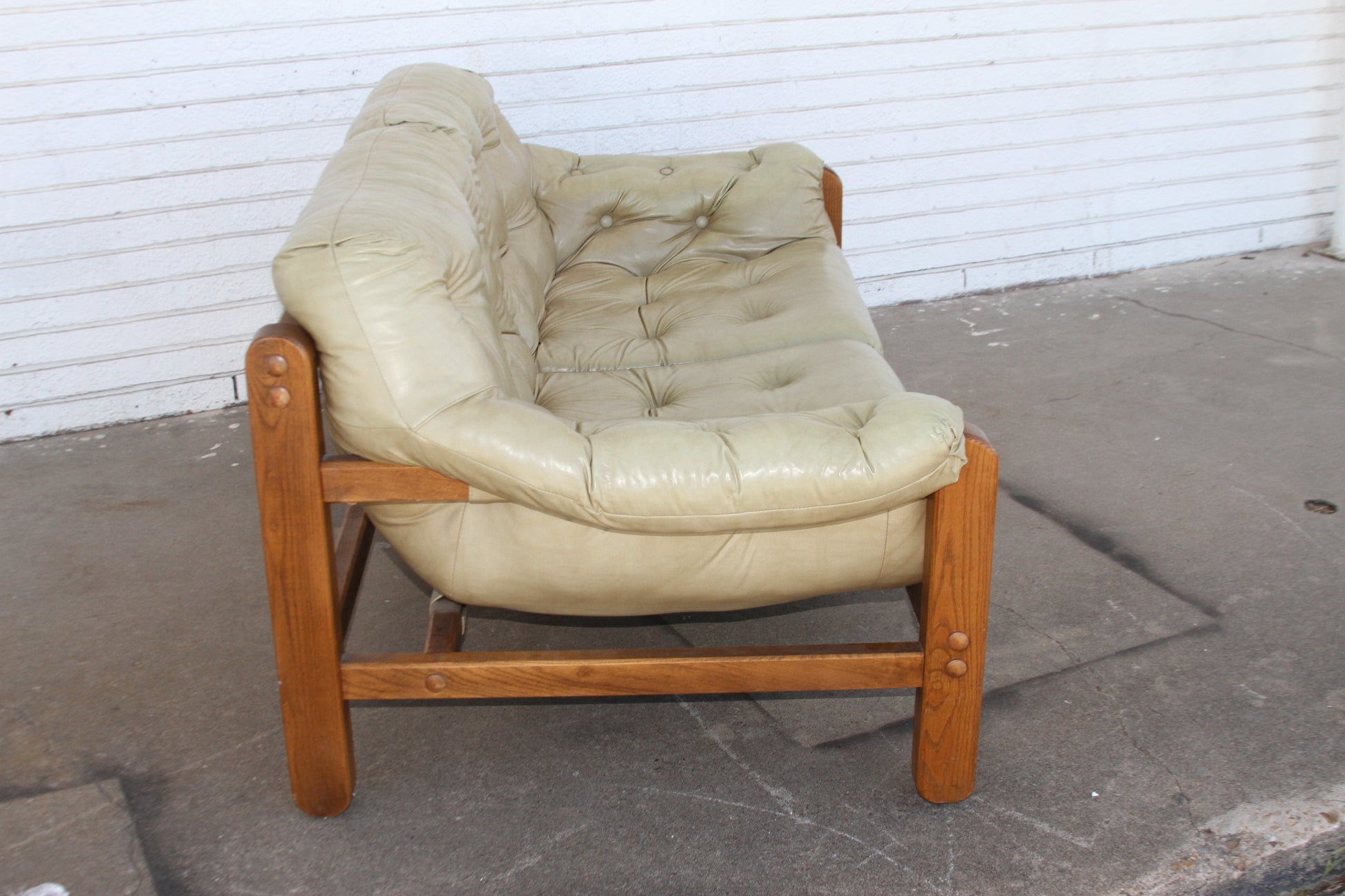 Mid-Century sophistication with this stunning teak loveseat. Crafted with premium materials, this love seat sofa is a true statement piece among couches for sale.