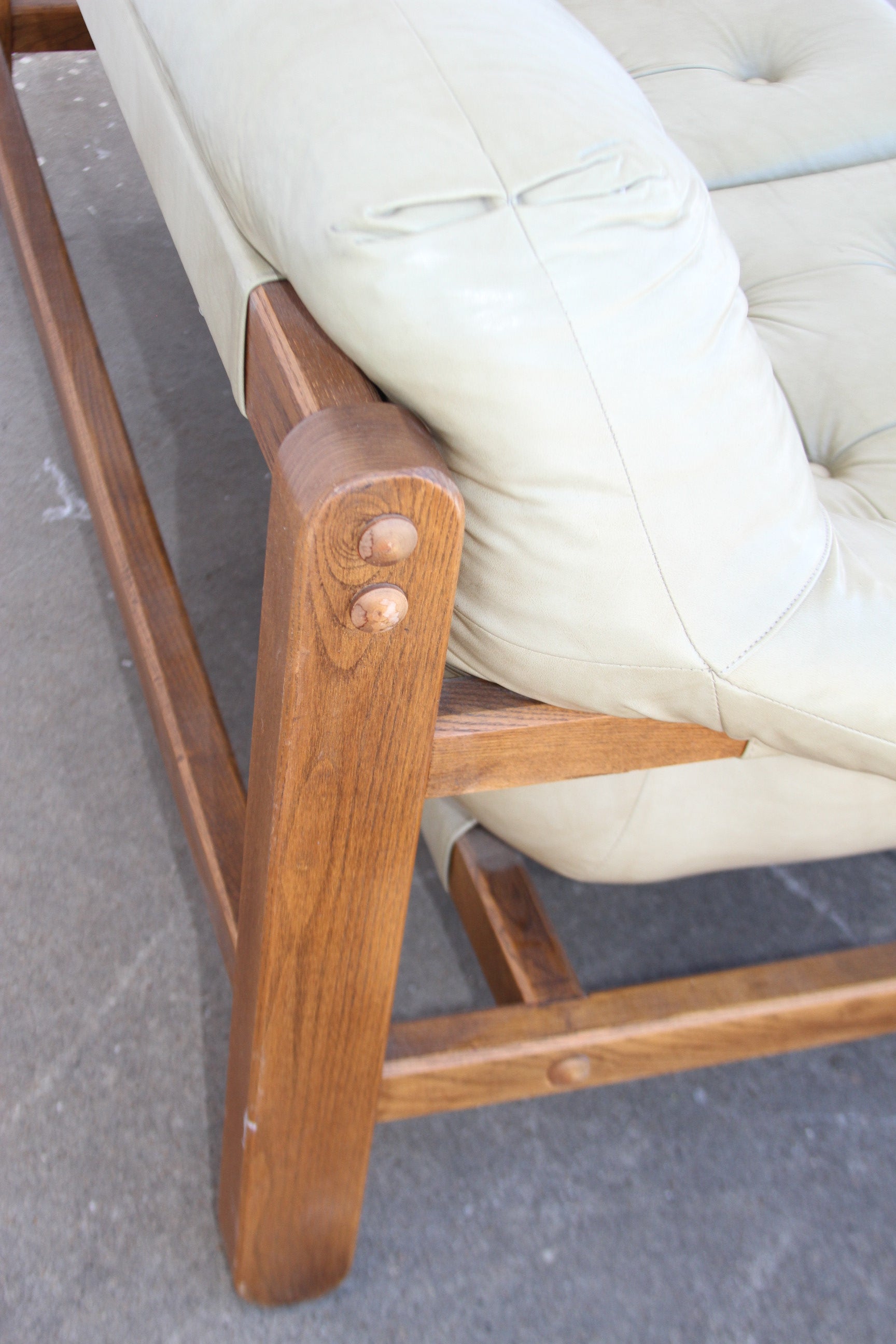  luxurious craftsmanship of this Mid Century teak loveseat. A true centerpiece, this love seat sofa is a rare gem among couches for sale.