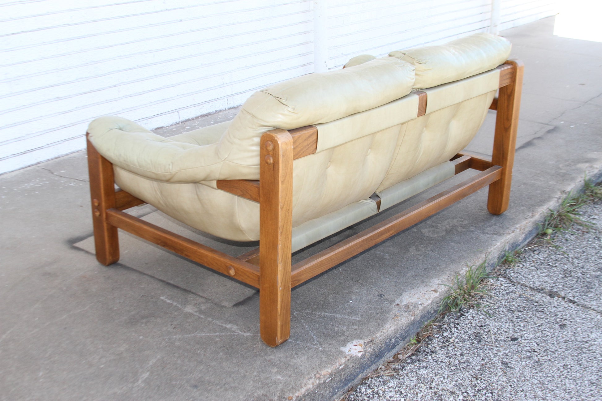 Transform your living room with the timeless charm of this Mid Century teak loveseat. Expertly crafted, this loveseat sofa is a statement piece that will elevate your decor.