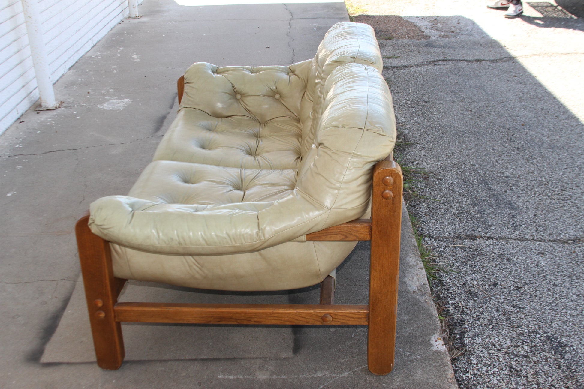 timeless elegance of this Mid Century teak loveseat. Its sleek lines and warm hues make this loveseat a standout addition to any living space.