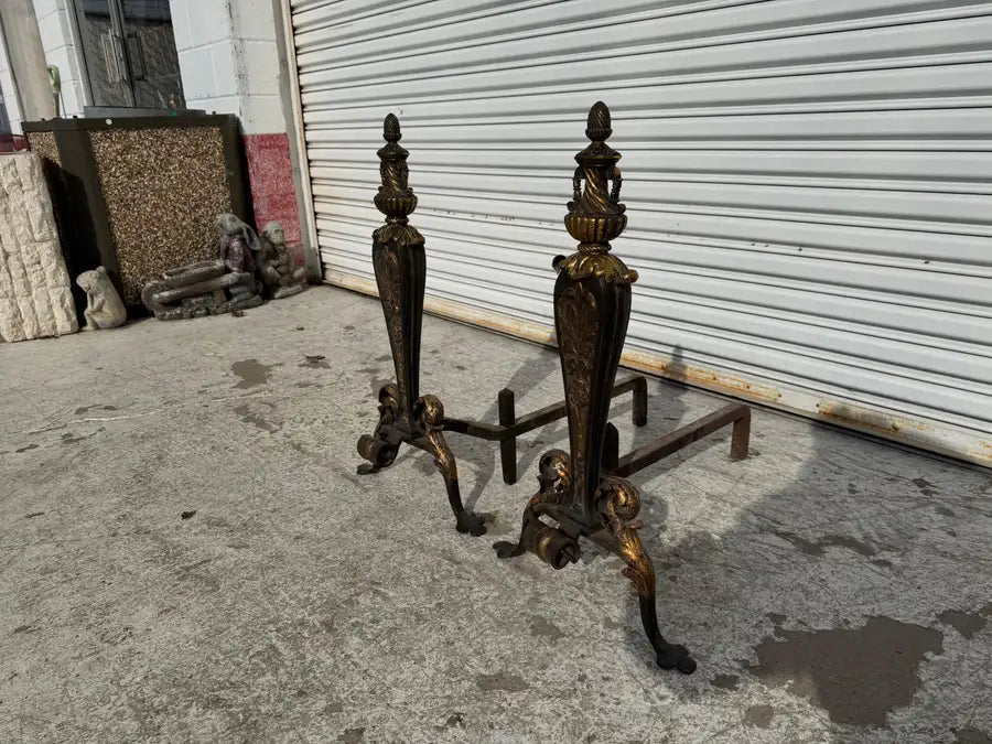 traditional iron andirons with intricate leaf design